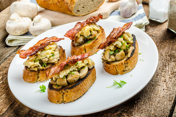 Rustic breakfast - bread toast, mushrooms, eggs