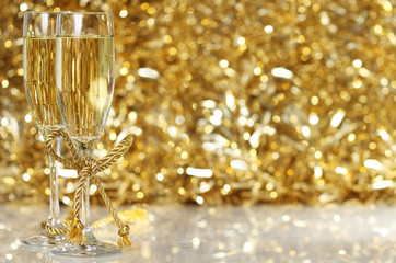 Champagne flutes with golden background