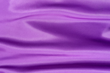 Fototapeta na wymiar Purple folded satin background
