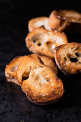 Toasted crusty baguette  on old black background
