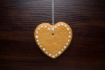 Christmas cookies hanging over wooden background