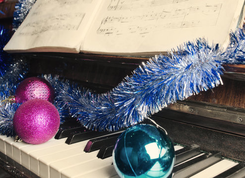 Christmas decorations lie on a piano