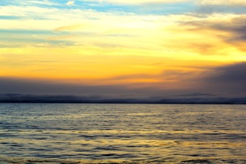 Naklejka na ściany i meble Golden sunset over the ocean