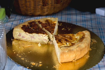 Cut quiche pieces on a picnic blanket