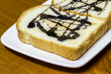 toasts topped with chocolate on the plate.
