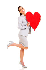 young woman holding heart shape