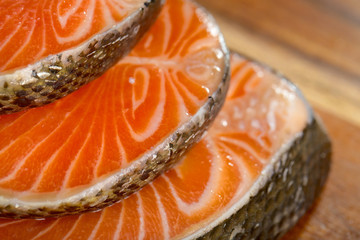 Delicious  portion of fresh salmon fillet on a wooden board