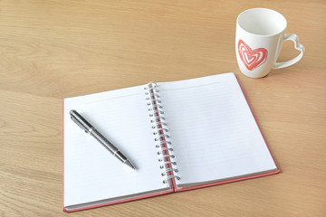 Open a blank white notebook and cup of coffee