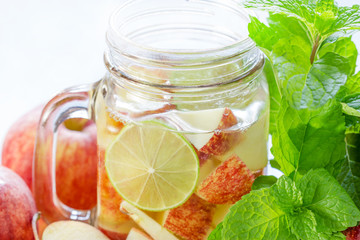 Mug delicious refreshing drink of apple fruits with mint on wood