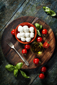 Cherry tomatoes, basil leaves, mozzarella cheese and olive oil f