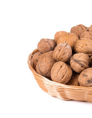 Wicker basket full of walnuts.