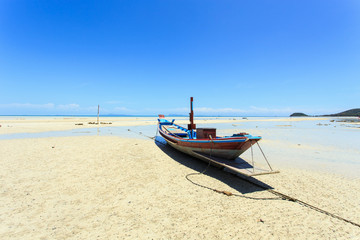 Fototapeta premium Traditional Thai boat or long tail boat stand at the beach