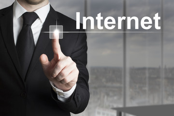 businessman pushing button internet