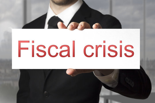 businessman holding sign fiscal crisis