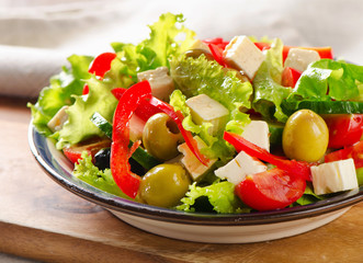 Fresh greek  salad with feta, olives and vegetables .