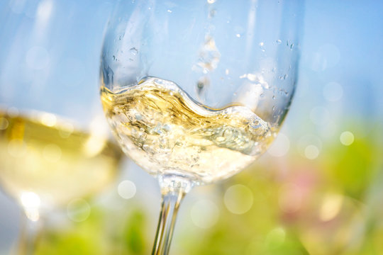 Naklejki Pouring white wine in a glass