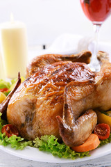 Delicious baked chicken on plate on table on light background