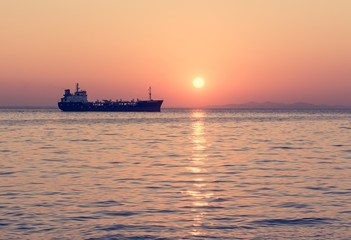 Cargo ship with setting sun