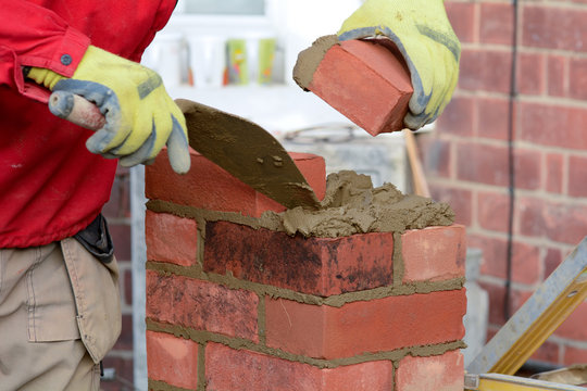 Bricklaying - laying a brick