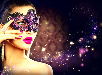 Sexy woman wearing carnival mask over holiday dark background