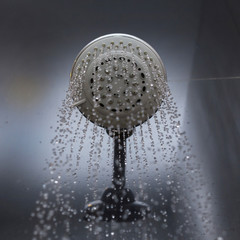 shower head with water drops flowing