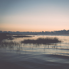 beautiful sunrise in the sea at the wild beach. Vintage.