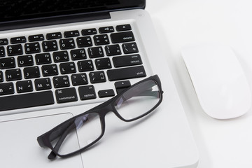 Obraz na płótnie Canvas Blank business laptop, mouse and glasses