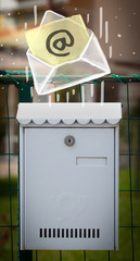 Envelope with email sign dropping into mailbox © ra2 studio