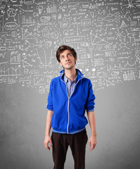 Young handsome guy with hand drawn calculations and icons