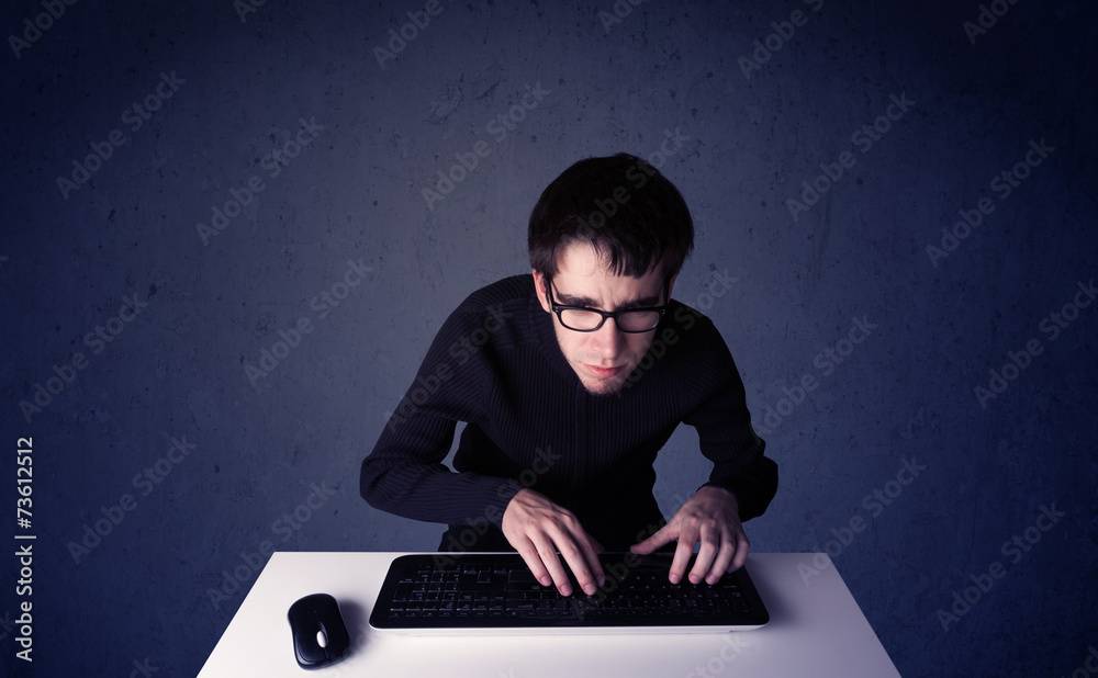 Fototapete hacker working with keyboard on blue background