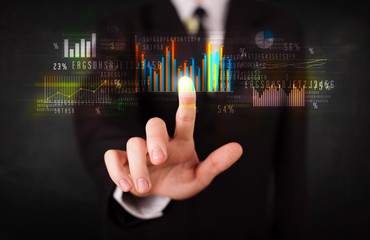 Young business person touching colorful charts and diagrams