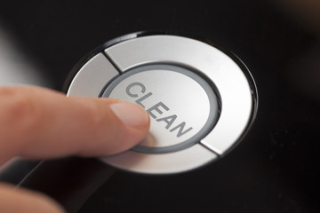 Woman's finger pressing the button Clean