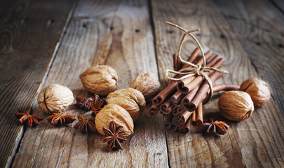 Christmas spices (cinnamon sticks, star anise, and walnuts)