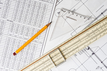 Schemes the pencil and triangle with slide rule on the table