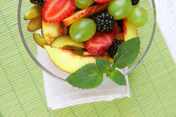 fresh tasty fruit salad on table