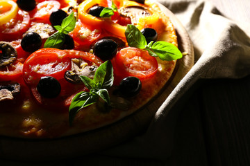 Delicious pizza served on wooden table