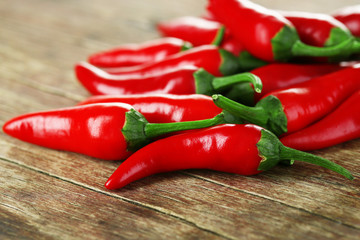 Red hot chili peppers on wooden background