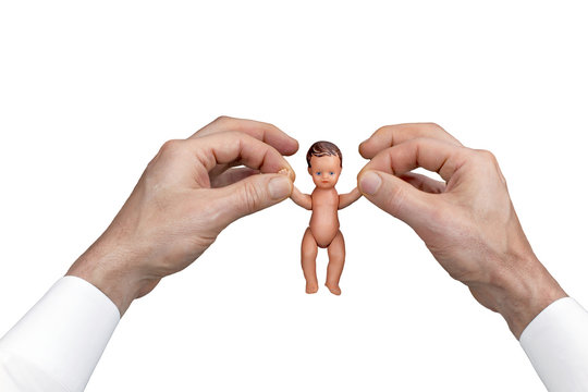 Two man's hands holding naked  baby doll