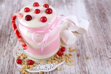Raspberry milk dessert in glass jar,