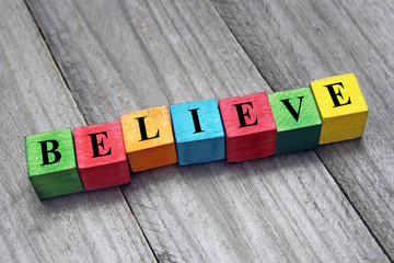 believe word on colorful wooden cubes