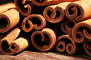 Cinnamon sticks on wooden background