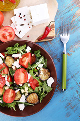 Eggplant salad with tomatoes, arugula and feta cheese,