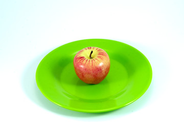 ripe red apple with green leaf isolated on white