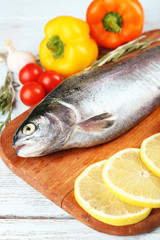 Fresh raw fish and food ingredients on table