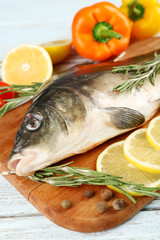 Fresh raw fish and food ingredients on table