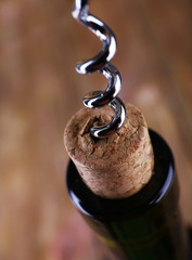 Bottle opener close-up, on wooden background