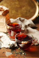 Beautiful vintage composition with herbal tea, on wooden table