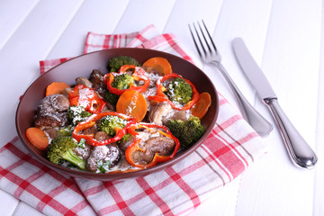 Braised wild mushrooms with vegetables and sauce in plate