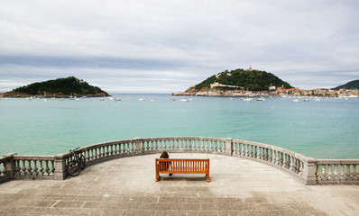 The woman sitting on the bench in San Sebastian.
