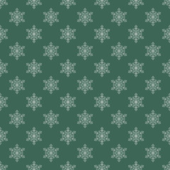Seamless background with snowflakes on green